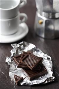 Pieces of milk chocolate on silver paper