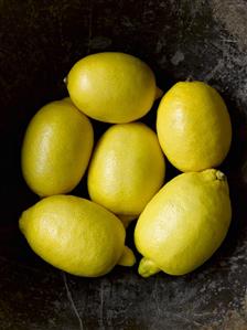 Six lemons in a fruit bowl