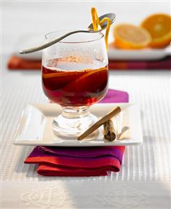 A glass of Christmas punch with orange slices