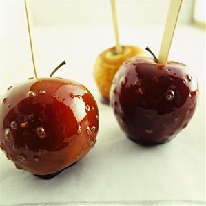 Three toffee apples with wooden sticks