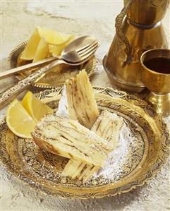 Three pieces of lemon cake with metal tableware