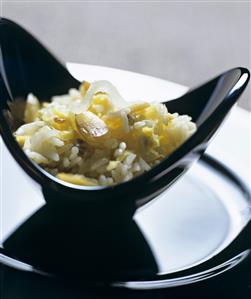 Rice with dried fruit in a black dish