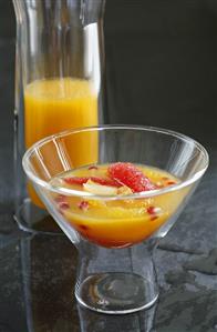 Orange punch in a glass and a carafe