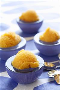 Orange sorbet in four glass bowls