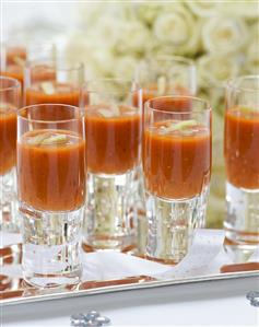 Gazpacho in glasses on a tray at a wedding reception