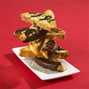 Anise biscotti with chocolate icing, stacked on a plate