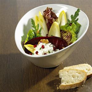 Salad leaves with goat's cheese, walnuts, pomegranate dressing