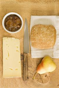 Cheddar cheese, apple chutney, bread and a pear