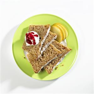 Slices of apple spelt bread with quark, jam, apple slices