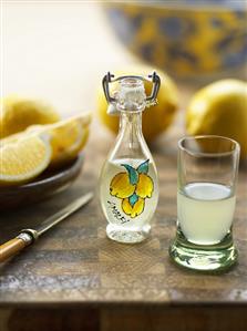 Limoncello in a small bottle and a glass (Amalfi, Italy)