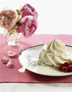 Cream with fresh raspberries and silver dragées