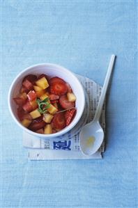 Strawberry and melon salad with lemon grass in a bowl