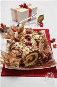 Chocolate roulade with gold leaf for Christmas