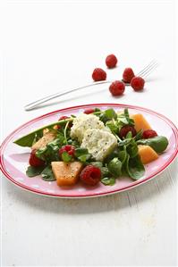 Goat's cheese on corn salad with melon and raspberries