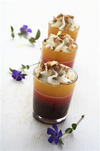 Layered fruit dessert with cream and nuts