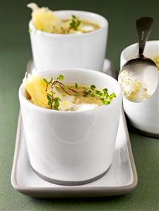 Lentil soup with thyme and cheese in two soup cups