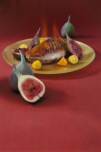 Flambéed duck breast with kumquats and figs