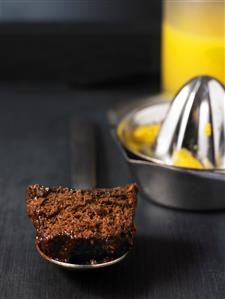 A piece of coffee cake with fondant and orange juice