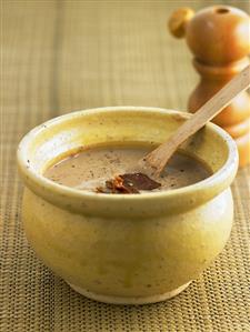 Cream of chestnut soup with coppa in a soup bowl