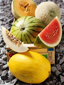 Assorted whole melons and melon wedges