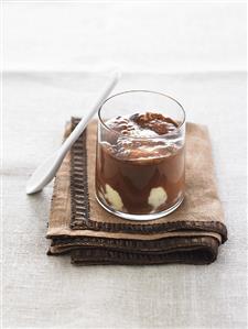 Vanilla ice cream with warm chocolate sauce in a glass