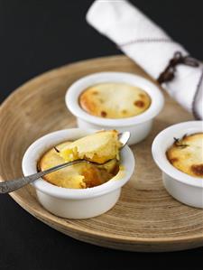 Individual peach puddings in baking dishes