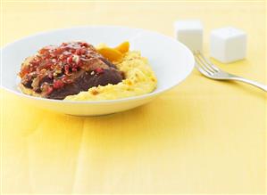 Duck breast with roasted red almonds and apricot polenta