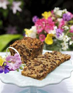 Fruit loaf on a cake stand decorated with flowers