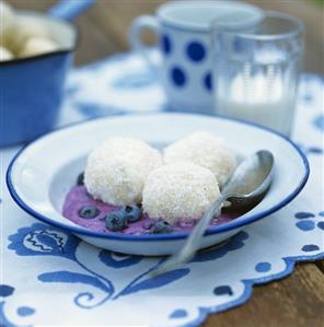 Blueberry and coconut dumplings on blueberry sauce