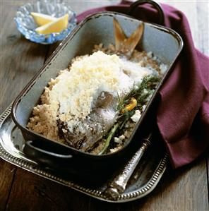 Sea bream with dill and lemon slices baked in salt