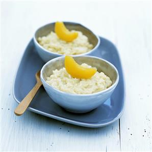 Two bowls of coconut rice pudding with peach