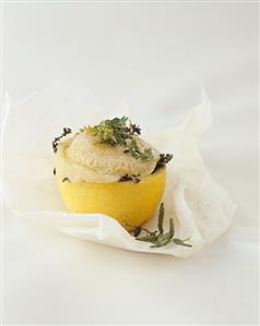 Goat's cheese with herbs in lemon, baked in parchment paper