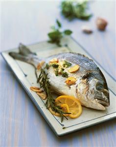 Gilthead seabream with garlic, herbs and lemon