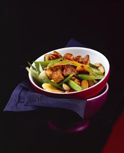 Sweet and sour belly pork with vegetables, bananas and nuts