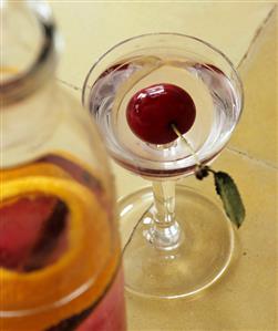 Home-made cherry liqueur in carafe and glass