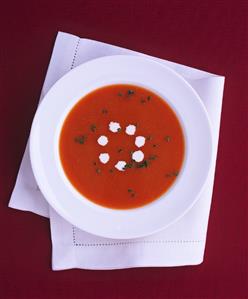 A plate of tomato soup with cream