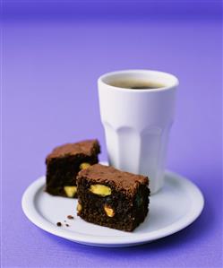 Pistachio brownies with a beaker of coffee