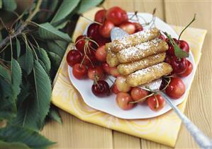 Potato noodles with nut & cinnamon crust on fresh cherries