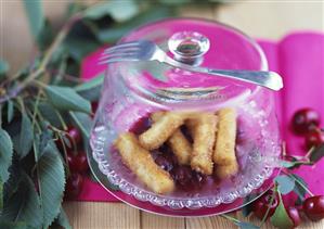 Potato noodles with nut and cinnamon crust and cherries