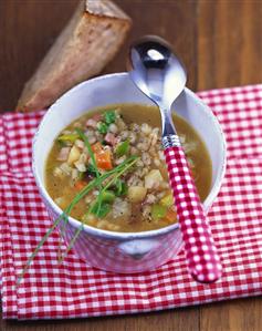 Hearty barley soup with vegetables and smoked bacon