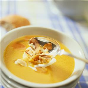 Carrot soup with coconut milk and coconut shavings