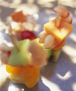 Fruit and prawns on cocktail sticks