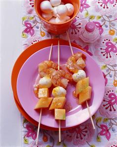 Three prawn, melon and mozzarella skewers