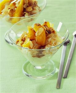 Rice pudding with peach slices and flaked almonds