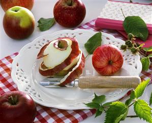 Apples, one peeled with peeler