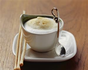 Fennel foam soup in cup with grissini