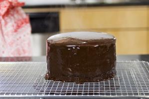 A cake freshly covered with chocolate