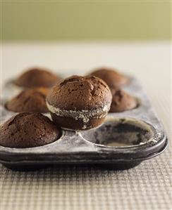 Chocolate muffins in a muffin tin