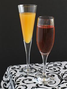 Two party cocktails in glasses: Kir Orange & Amarena Cherry