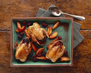 Roast partridges with blackberries and apple wedges